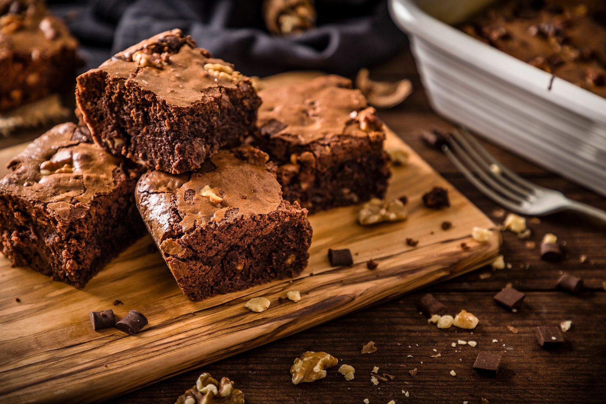 Freshly baked gourmet brownies arranged on a wooden board